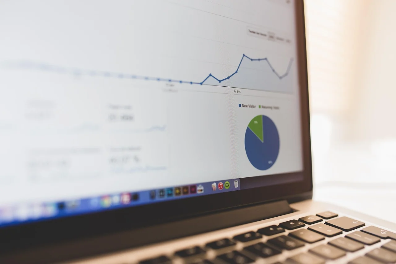 Laptop screen showing Semrush keyword research dashboard with graphs and keyword lists